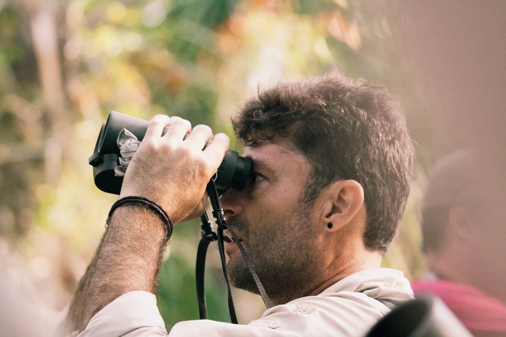 man looking through binoculars